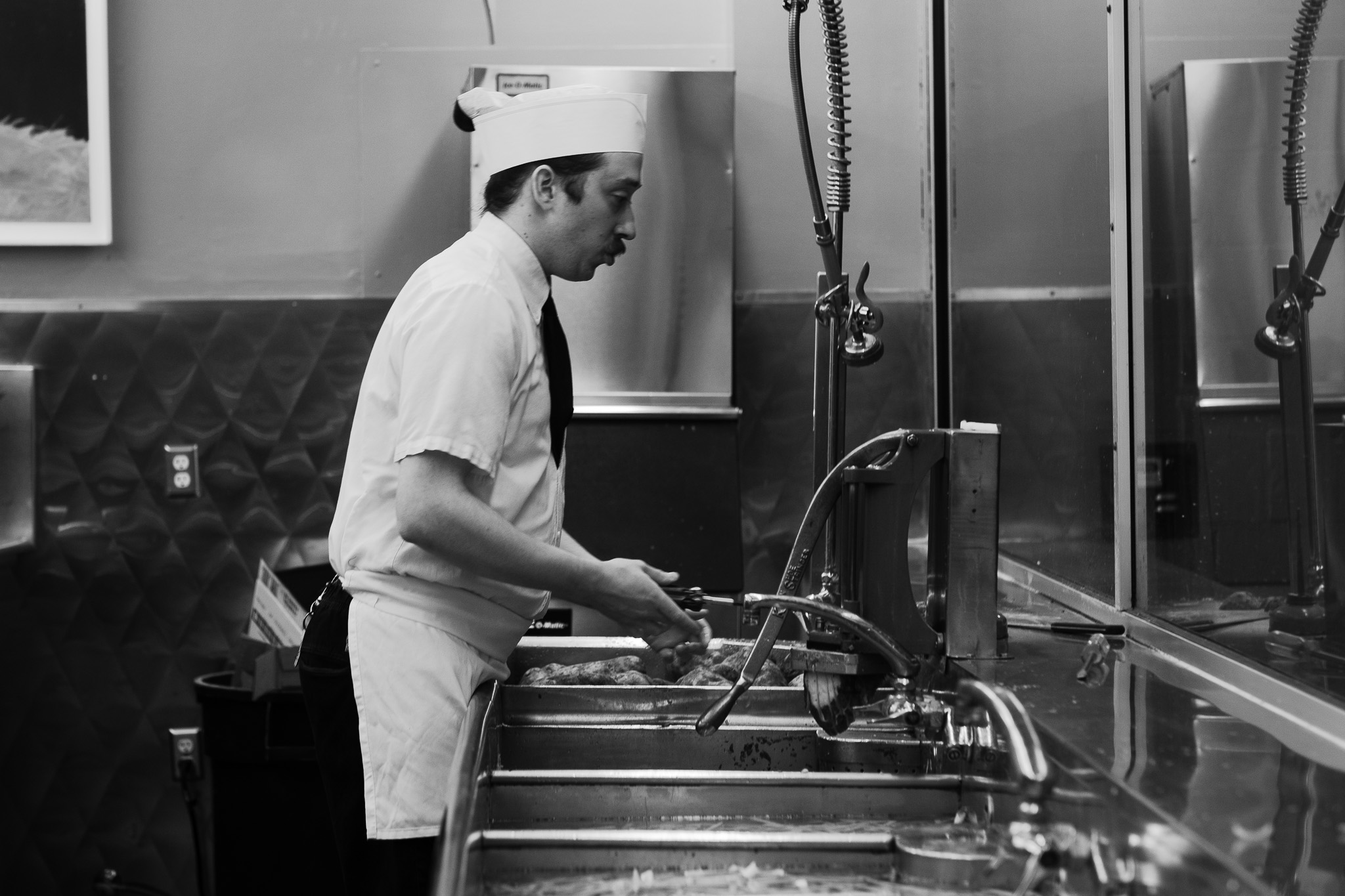 Man Adjusts the Faucet