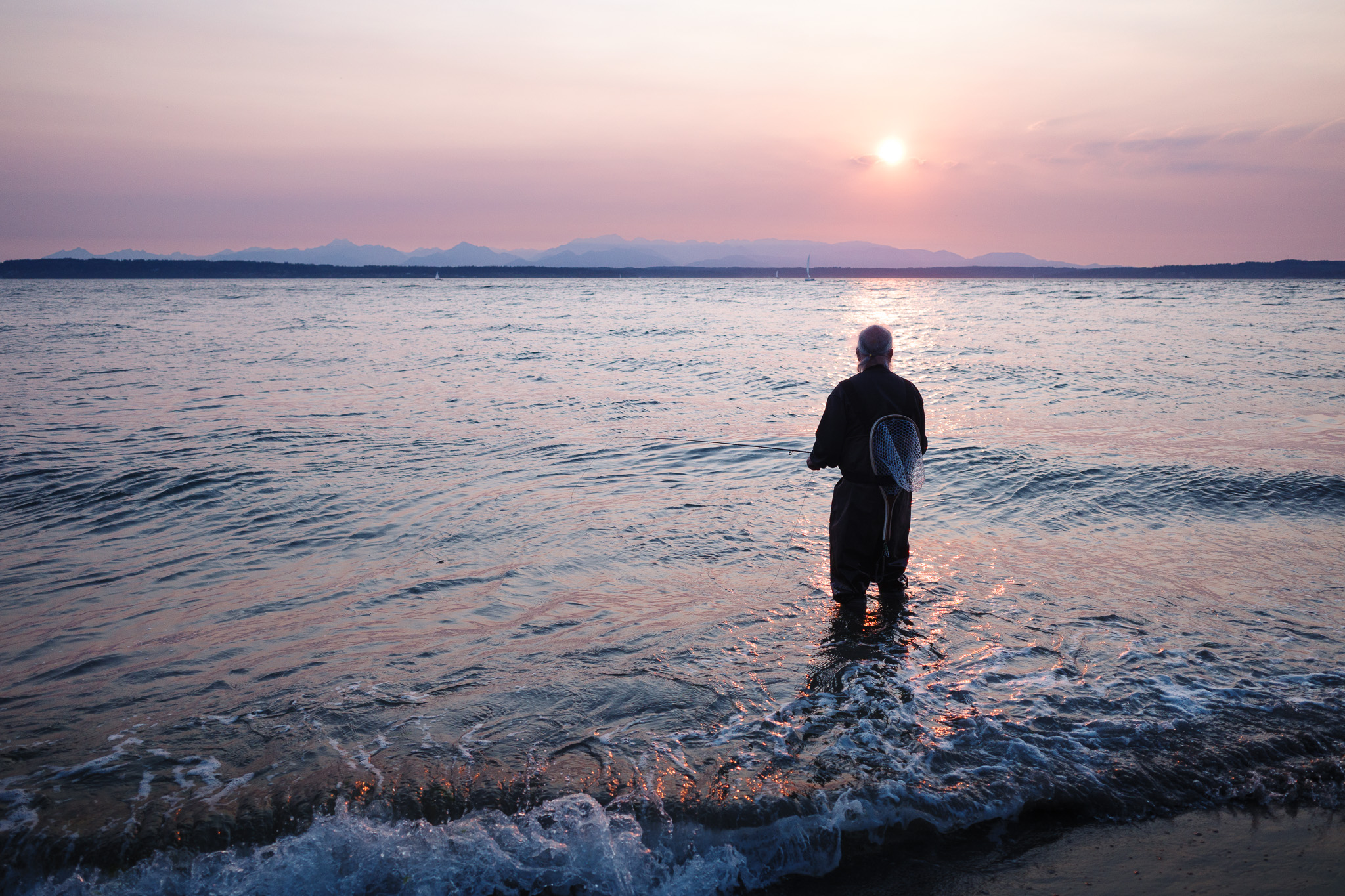 Men fishing at sunset.